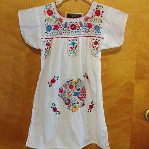 Handmade typical embroidery dress of the girl.